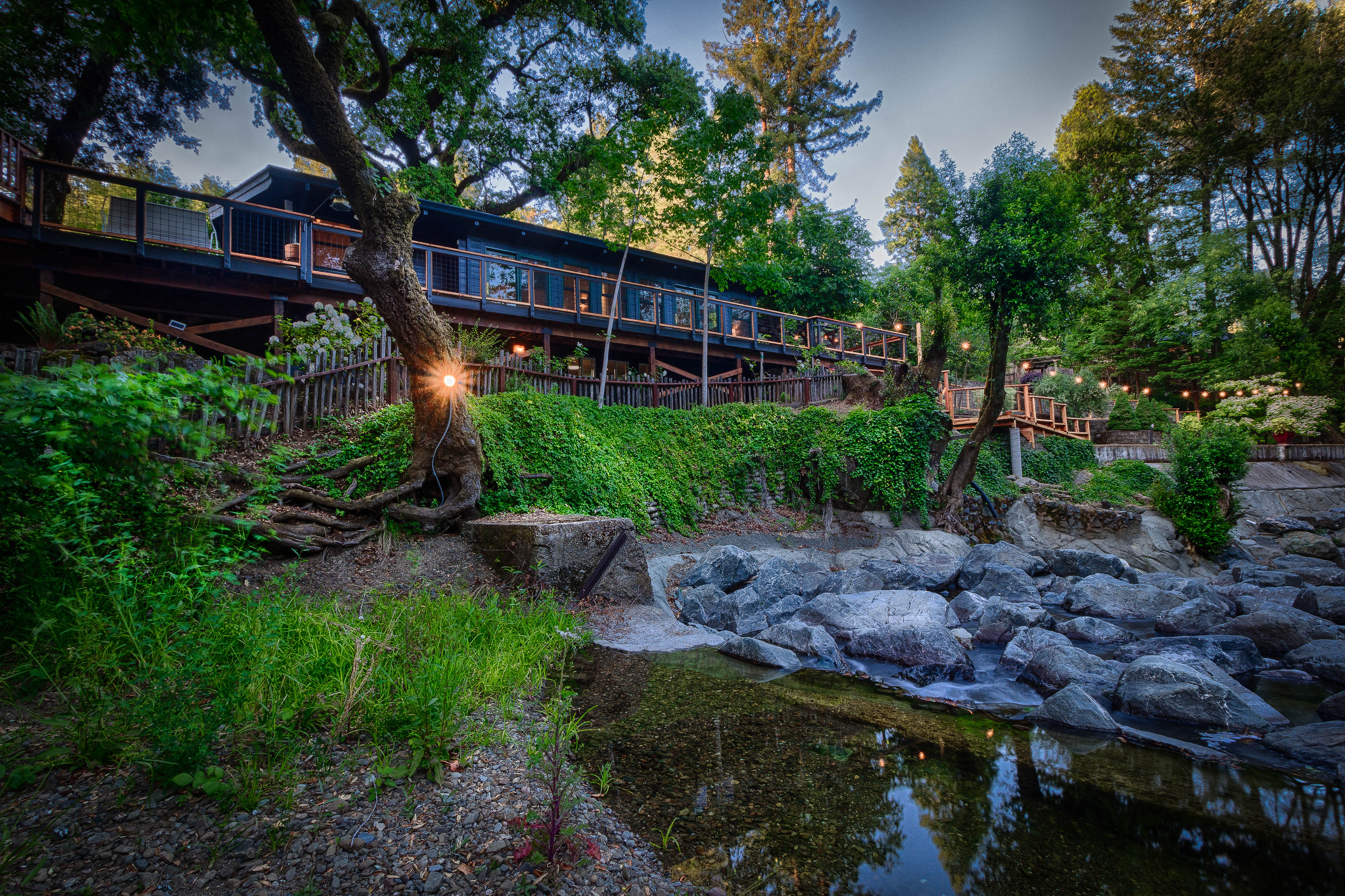 Mill Creek moving over stones below the long cabin deck