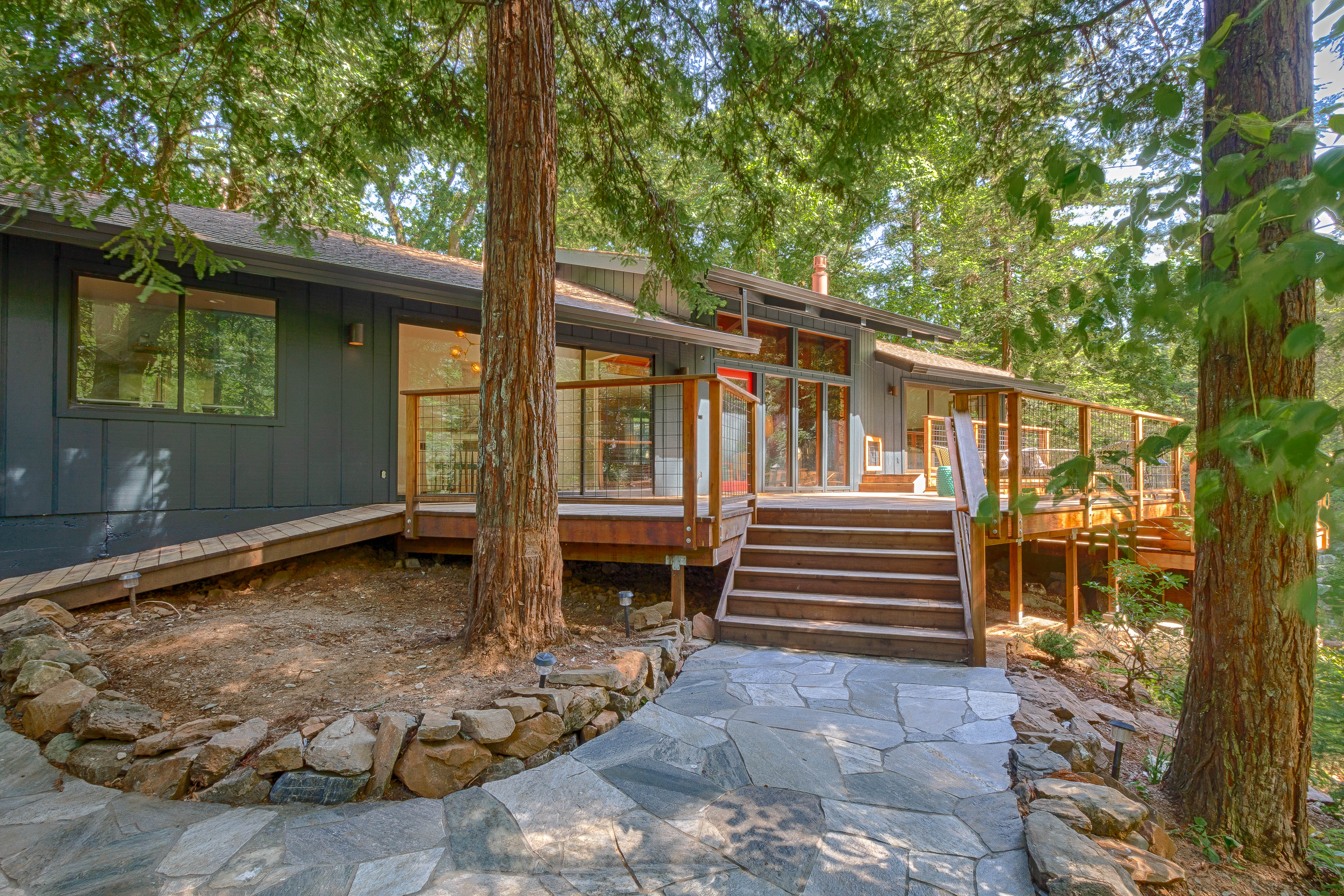 The cabin entrance and deck beneath tall redwoods